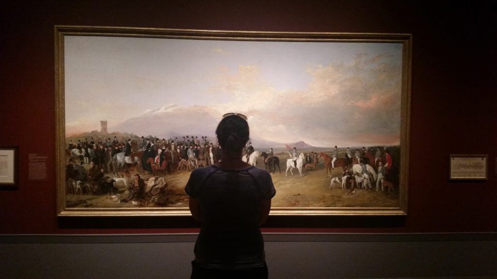 Linda studying artwork