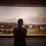 Linda studying artwork